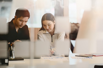 Two UX Ui designers with laptop meeting in modern office