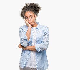 Young afro american woman over isolated background thinking looking tired and bored with depression problems with crossed arms.