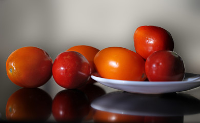 Ripe yellow and red tomatoes lying on the table