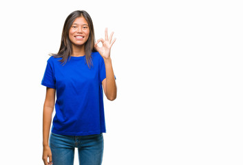 Young asian woman over isolated background smiling positive doing ok sign with hand and fingers. Successful expression.