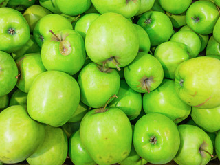 Green ripe apples in the store