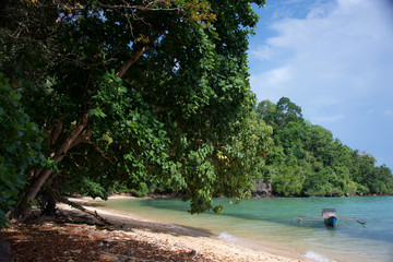 Remote beach with wooden fishing boat