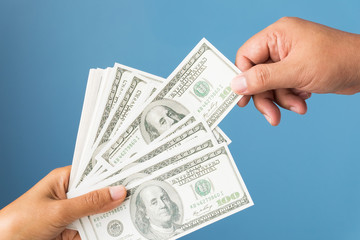 Dollars Banknote Currency Business Concept, Close-up of Hands Holding Money on Blue Background