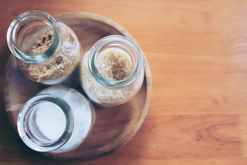 Bottles of Sugar on Wooden Table