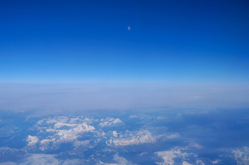 Fototapeta na wymiar Sky over the Swiss Alps with moon over top