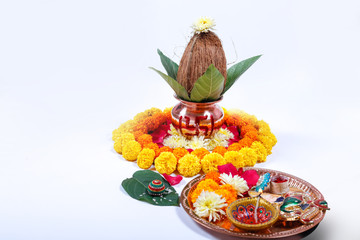 Copper Kalash with coconut , leaf and floral decoration on a white background. essential in hindu puja.