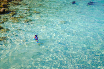 Snorkeling in crystal clear water in Perhentian Island.
