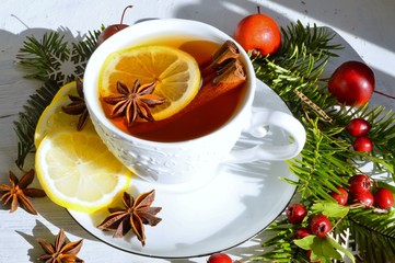 Hot tea  with spices on a wooden background. Selective focus.Still life, food and drink, seasonal and holidays concept.
