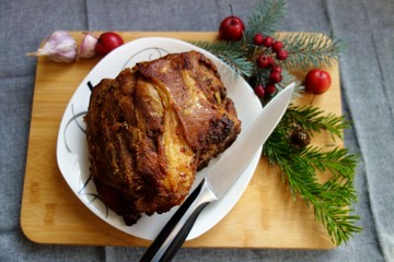 Fototapeta na wymiar Pork roasted meat - pork neck in herbs and spices. Christmas roast 