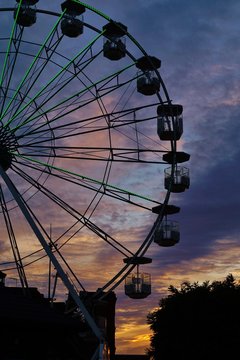    Ferris wheel carousel against the background of the setting sun
