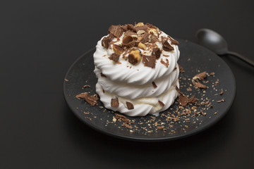 Pavlova meringue cake with cream chocolate and nuts.