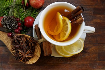 Hot tea  with spices on a wooden background. Selective focus.Still life, food and drink, seasonal...