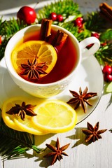 Hot tea  with spices on a wooden background. Selective focus.Still life, food and drink, seasonal and holidays concept.
