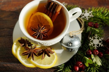 Hot tea  with spices on a wooden background. Selective focus.Still life, food and drink, seasonal and holidays concept.
