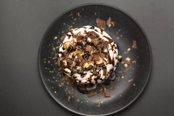 Meringue dessert with chocolate sauce, chocolate, nuts and cream.