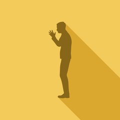 Silhouette of businessman in prayer pose. Web icon with long shadows for application