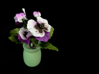 flowers in vase on black background
