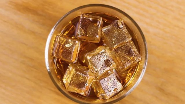 Whiskey glass with ice cubes inside. Top view.