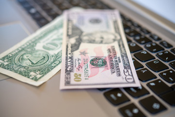 computer keyboard with dollar bank notes