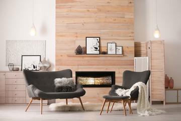 Cozy living room interior with comfortable furniture and decorative fireplace - obrazy, fototapety, plakaty