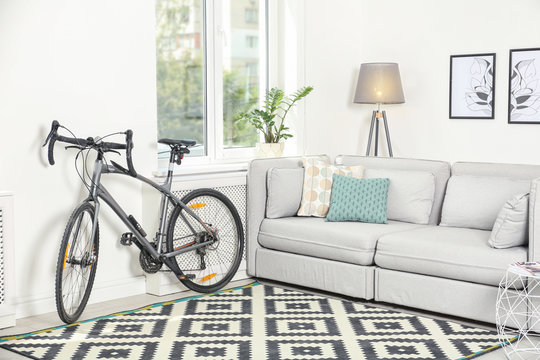 Modern living room interior with bicycle near wall