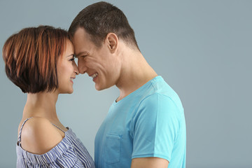 Fototapeta premium Portrait of cute loving couple on color background