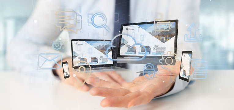 Businessman holding a Devices connected to a cloud multimedia network 3d rendering