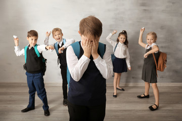 Children bullying their classmate indoors
