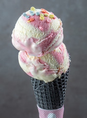Ice cream balls in black waffle cone