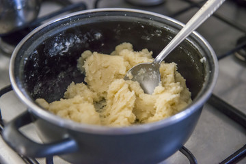 Preparing dough in a cooking pot 