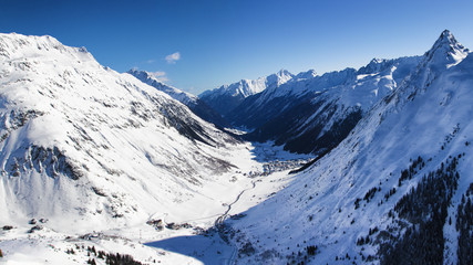 Fototapeta na wymiar Winter alpine valley panorama, Paznaun Valley with Wirl, Galtur and Ischgl villages in background, Austria