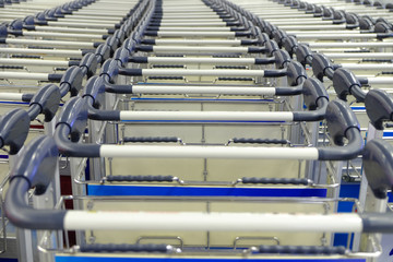 Handles of empty carts in straight rows