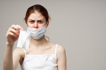 woman wearing a medical mask holding a napkin in her hand