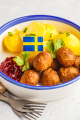 Swedish meatballs with boiled potatoes and cranberry sauce. Swedish  traditional food concept.