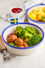 Swedish meatballs with broccoli, boiled potatoes and cranberry sauce. Swedish  traditional food concept.