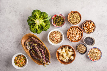 Vegan protein source. Tofu, beans, chickpeas, nuts and seeds on a white background, top view, copy space.