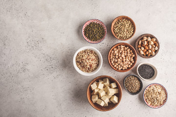 Vegan protein source. Tofu, beans, chickpeas, nuts and seeds on a white background, top view, copy space.