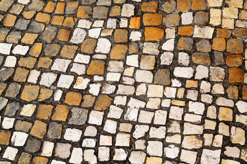 Pavement of brown and white. The geometrical pattern. The texture of the pavement