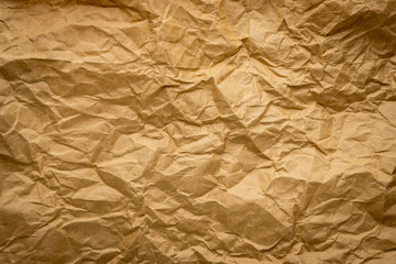 Ragged crumpled brown kraft paper texture background