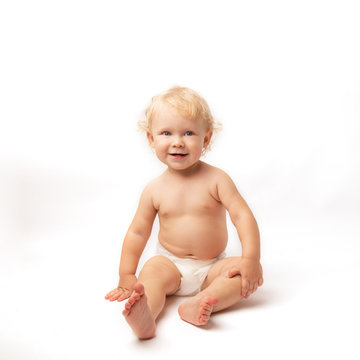 Infant child baby girl in diaper laughs happy looking at the camera isolated on a white background