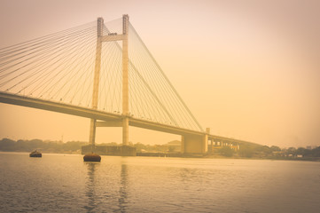 Fototapeta na wymiar View of historic Second Howrah Bridge on Hooghly river Kolkata India
