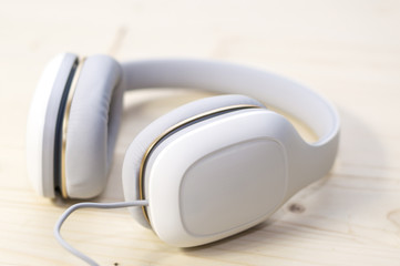 White headphones on wooden background