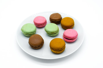 macarons on plate, sweet colorful macarons on white background