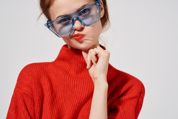 pretty woman in red sweater on bright background