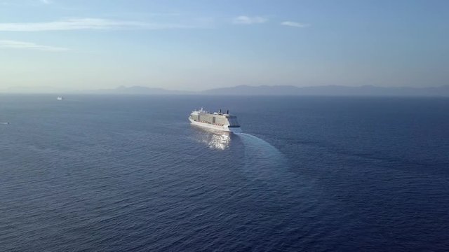 Aerial footage of mega cruise ship cruising the Mediterranean Sea.