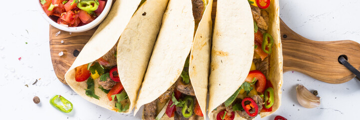 Mexican pork tacos with vegetables and salsa.