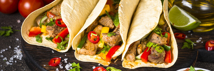 Mexican pork tacos with vegetables and salsa.