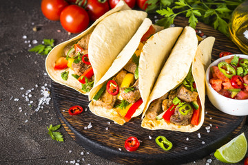 Mexican pork tacos with vegetables and salsa.