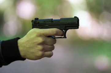 Hand holding gun, danger theme