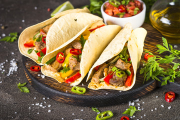 Mexican pork tacos with vegetables and salsa.